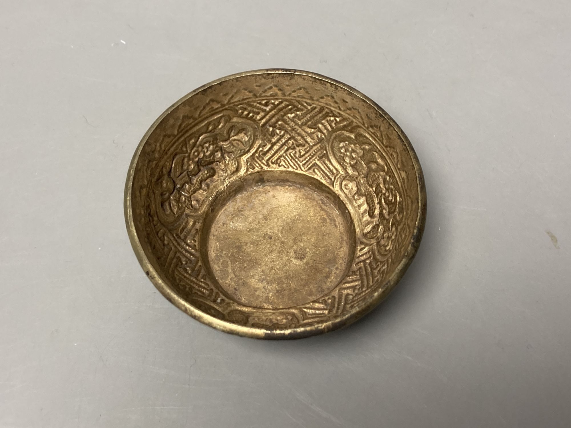 A Sino-Tibetan repousse base metal tea bowl, diameter 8cm